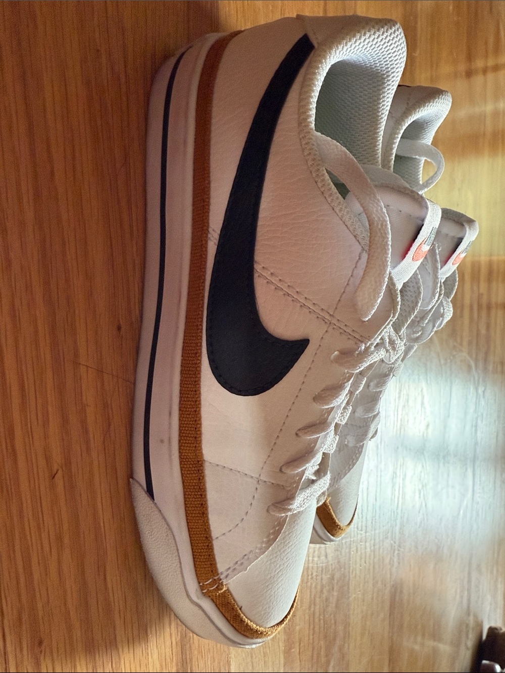 Nike Women’s White Sneakers with Black Swoosh and Brown Accent